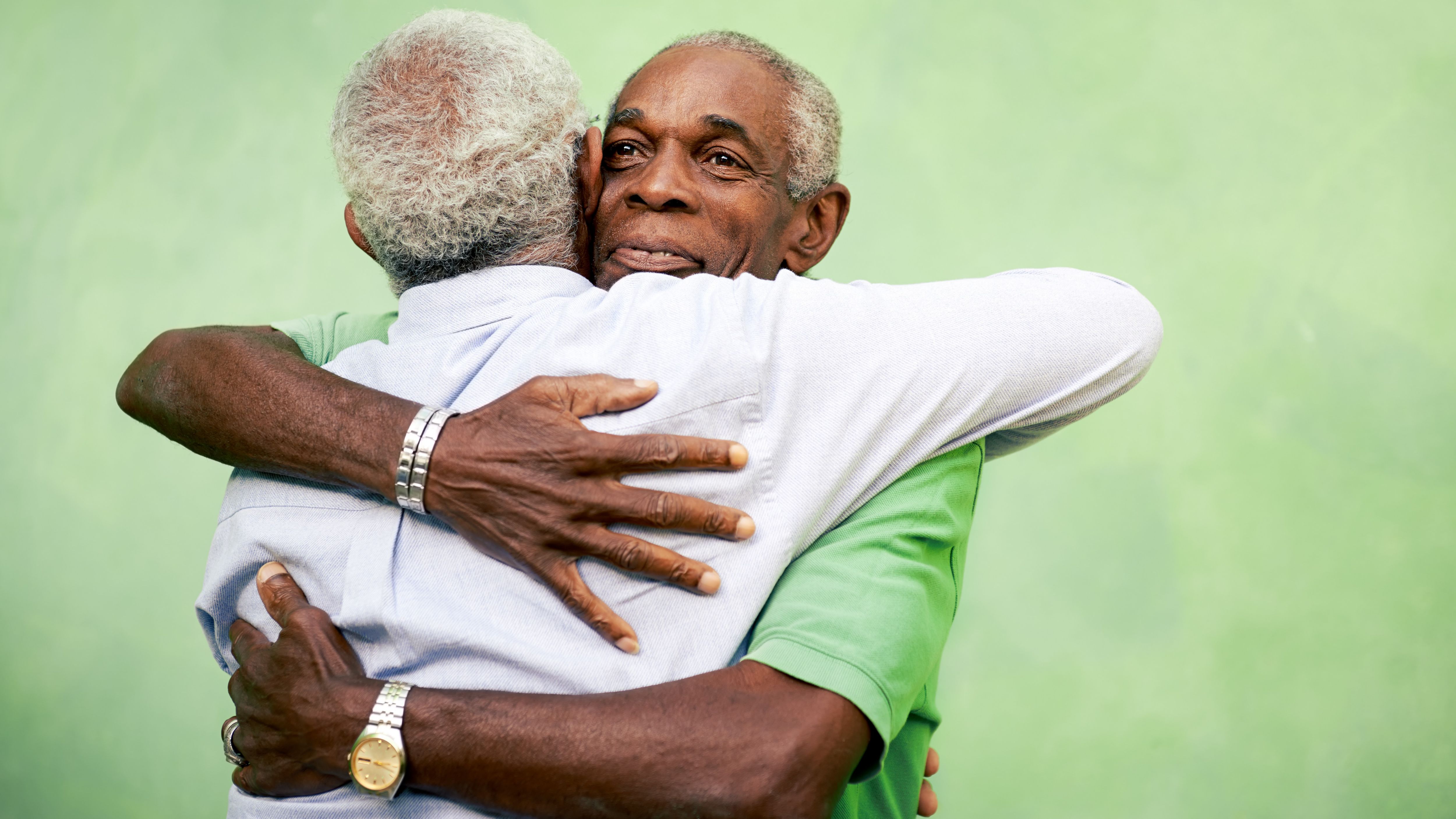 Active retired old men and leisure, two senior black brothers hugging outdoors
